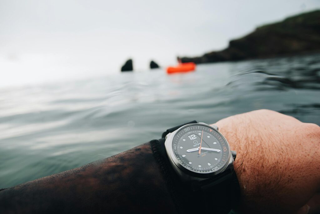 A close-up of a diver's watch in the ocean at Agde, France, symbolizing adventure and time.