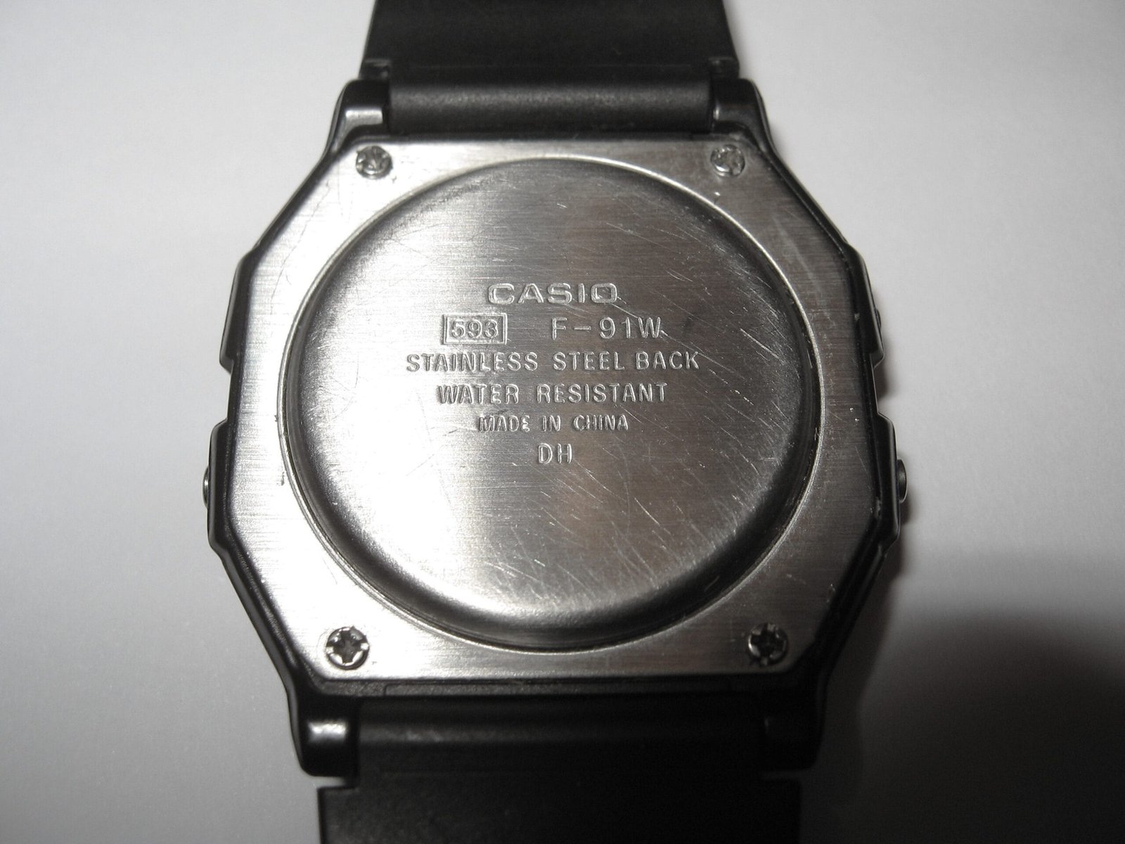 Stainless steel caseback of a Casio F-91W showing the stamped module number