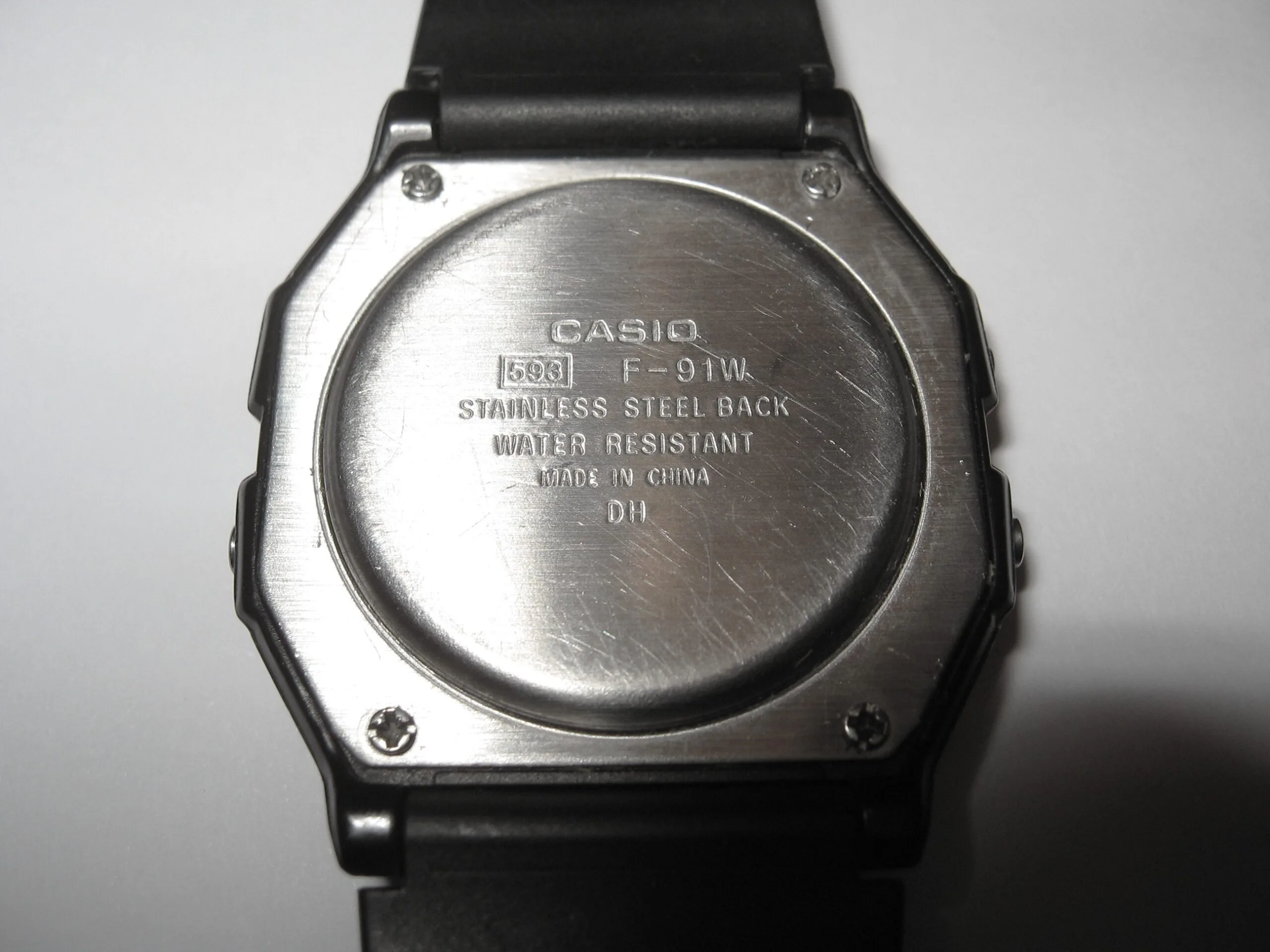 Stainless steel caseback of a Casio F-91W showing the stamped module number