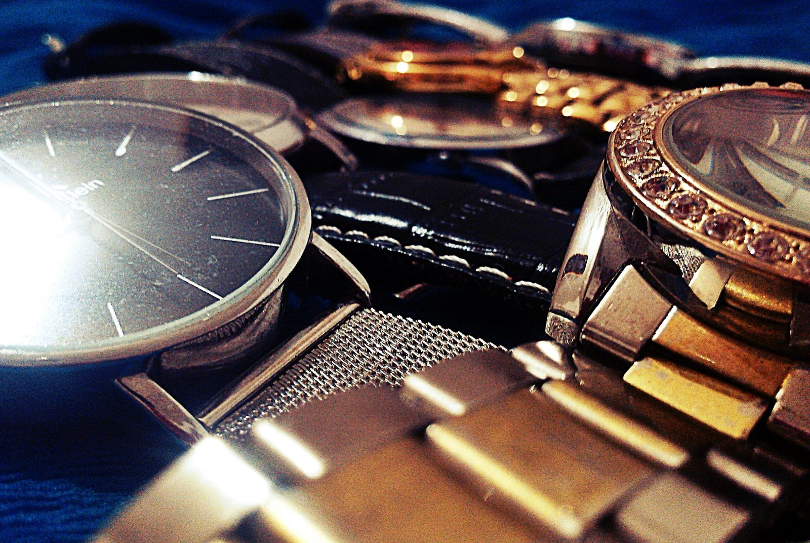 A personal collection of several wristwatches laid out together