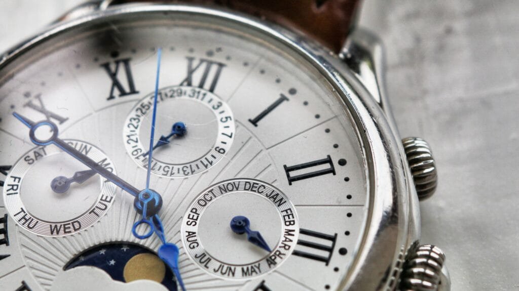 Close-up of an analog wristwatch dial with a seconds hand